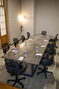 a large conference table with chairs and water bottles on it at Hotel San Francisco Tlaxcala in Tlaxcala de Xicohténcatl