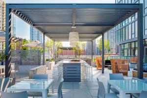 a rooftop patio with tables and chairs and a view of the city at Level Chicago Old Town in Chicago