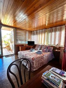 a bedroom with a bed and a table with a chair at Casa Lunastella Locazione Turistica in Mondello