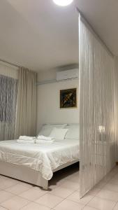 a bedroom with a white bed with a sliding door at Casa Valentina 3 in Perugia