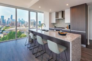 a kitchen with a large counter with stools at Level Chicago Old Town in Chicago