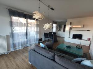 a living room with a couch and a table at Bella Vista - New flat with View Confort & Calm near Geneva 5 PERS in Archamps