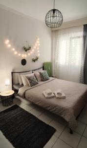a bedroom with a large bed with two towels on it at Evaggelia's Apartments 1 Διαμονή στο κέντρο in Kozani