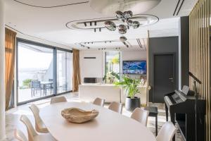 a dining room with a white table and chairs at Meltemi Villas Crete in Heraklio Town