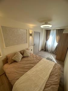 a bedroom with a large bed with pillows on it at Angel House in Deva