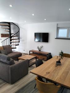 a living room with a couch and a table at Au fil de l'eau in Lapoutroie