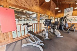 a gym with several treadmills and exercise bikes at Mountainside at Stowe by CoolVacay in Stowe