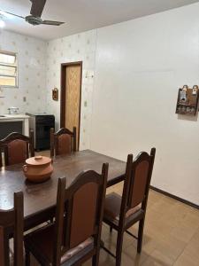 a dining room table with chairs and a bowl on it at APARTAMENTO TOP, Conforto e Qualidade in Guarapari