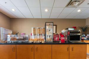 a counter with a bunch of donuts on it at Best Western Plus South Edmonton Inn & Suites in Edmonton