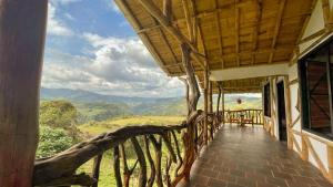 a balcony of a house with a view of the mountains at Hotel Rancho Maju in San Agustín