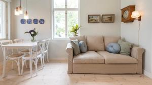 a living room with a couch and a table at Villa Maija 4 Upperside in Hanko