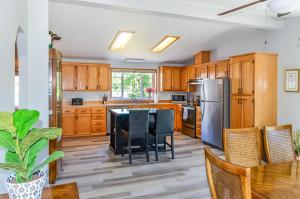 a kitchen with wooden cabinets and a table and chairs at Peak View Corvallis - Spacious Outdoor Dining w/Fire Table - Close to Downtown & OSU in Corvallis