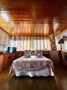 a bedroom with a bed in a room with wooden ceilings at Casa Lunastella Locazione Turistica in Mondello