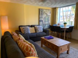 a living room with a couch and a table at Arrochar Alps Apartment in Arrochar