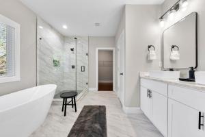 ein weißes Badezimmer mit Badewanne und Dusche in der Unterkunft Family Friendly New Luxury Home Centrally located in Atlanta + 25 Fotos