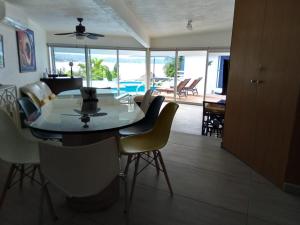 a dining room and living room with a table and chairs at Casa Azul en la orilla del Lago Tequesquitengo in Tequesquitengo