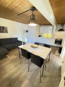 a living room with a table and a couch at Chalet Saint-Patrick - Le Cosy in Vars