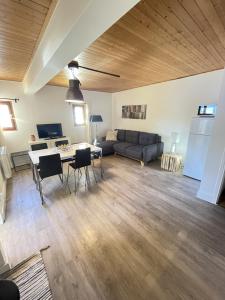 a living room with a table and a couch at Chalet Saint-Patrick - Le Cosy in Vars