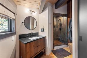 a bathroom with a sink and a shower at Birchwood Retreat by Tahoe Getaways - Newly Remodeled Pet Friendly Home in Alpine Meadows with Wood Fireplace, Hot Tub & Ski Shuttle! in Alpine Meadows +17 photos