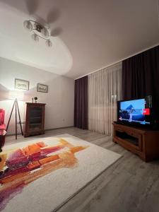 a living room with a television and a bed at Apartman “ Ismar “ in Travnik