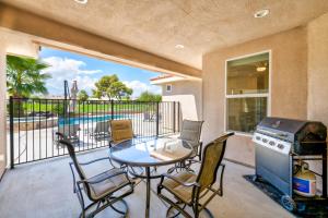 a patio with a table and chairs and a grill at Palms Place in Indio in Indio