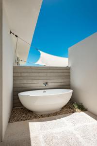 a bathroom with a white bath tub in a room at Ocean Dream 5 BR Villa Aqua in Long Bay Hills