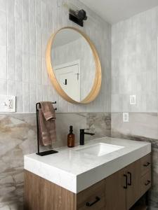 a bathroom with a sink and a mirror at Casa Wabi on Park Lane in Dallas + 2 King Beds in Dallas