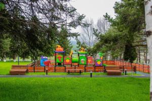 a colorful playground in a park with benches at 20%off to Bakuriani amenities in Bakuriani