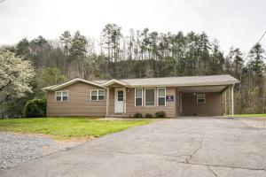 a house with a driveway in front of it at Sevierville Home with Hot Tub about 4 Mi to Dollywood! in Sevierville