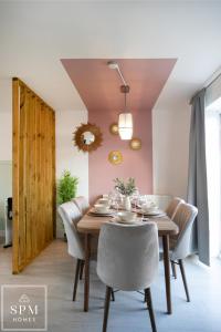 a dining room with a wooden table and chairs at 4 Bed Contractor House-Parking-WiFi-Smart Tvs in Each Bedroom-Special Rates Available in Peterborough