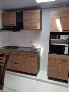 a kitchen with a sink and a microwave at Apartamento1 bien ubicado en Tuluá in Tuluá