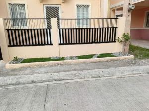 a black fence in front of a house at Al-ED Homestay in Butuan