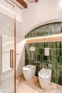 a bathroom with a toilet and a sink at Parco Ducale Design Rooms in Parma