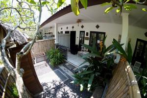 an outside view of a house with plants at Jepun Villas 08 - One Bedroom with 3 beds and kitchen in Uluwatu +8 photos