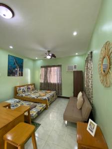 a room with two beds and a couch and a table at Spacious Studio Apartment 3 with Pool in Alburquerque +18 photos