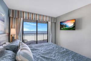 a bedroom with a bed and a view of the ocean at Ideally situated beachfront condo with pool and views in Marco Island +27 photos