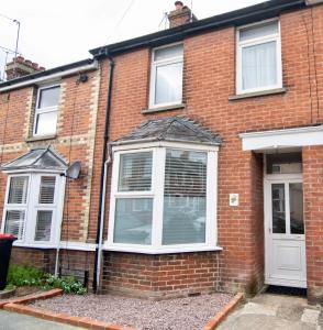 a brick house with a white door and windows at Boursault Rose *4 Bed *WiFi *Canterbury in Canterbury