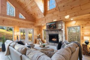 a living room with a couch and a fireplace at Fairway Lodge On One in Beech Mountain
