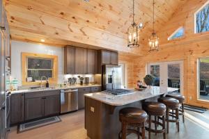 a kitchen with wooden walls and a wooden ceiling at Fairway Lodge On One in Beech Mountain +35 photos