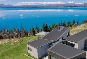 an aerial view of a house on the edge of a lake at Lake Pukaki Lake House in Lake Pukaki