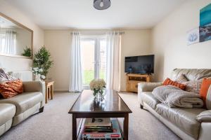 a living room with a couch and a table at Grenadier House in Coventry