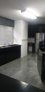 an empty kitchen with a sink and a refrigerator at The Concept in Centurion