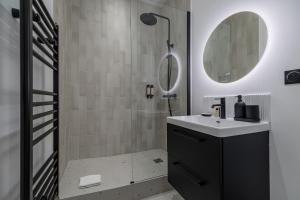 a bathroom with a sink and a mirror at Poetic Stay - Champs Elysees in Paris