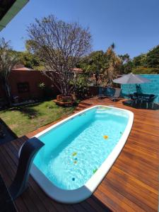 a hot tub on the deck of a house at Hostel Trem Di Durmi in Belo Horizonte