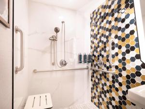a bathroom with a shower with a checkered shower curtain at DoubleTree by Hilton Livermore, CA in Livermore