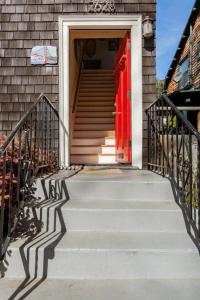a house with a red door and a staircase at Private room in the heart of Elmwood Berkeley! in Berkeley