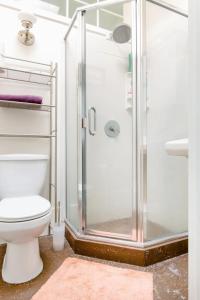 a bathroom with a toilet and a glass shower at Private room in the heart of Elmwood Berkeley! in Berkeley