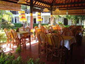 a group of tables and chairs in a restaurant at Palm Garden Hotel in Sanur