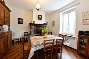 a dining room with a table and a fireplace at Etchevers-enia in Suhescun