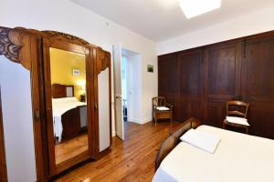 a bedroom with a bed and a mirror at Etchevers-enia in Suhescun